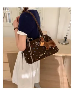 Brown suede tote bag featuring star prints, a plaid ribbon, and a dog plush charm detail