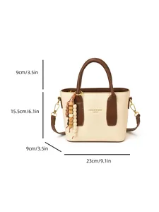 Chic cream and brown leather bucket bag with dimensions and wooden bead tassel