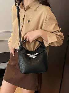 Chic black bucket bag with silver knot detail and adjustable crossbody strap