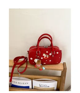 Detail of red Boston bag with star patterns, embroidery, and a horse plush charm