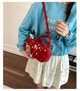 Detail of red baguette bag with star print, horse embroidery and cute bear charm