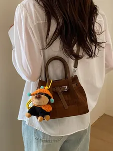 Deep brown matte trapezoid handbag with shoulder strap and cute dog plush pendant