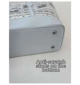 Detail view of large tote bag bottom with protective silver studs and cute pattern