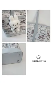 Detail view of light blue tote bag featuring cute foal prints and a plush rabbit charm