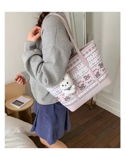 Detail of pink and white patterned tote bag with a cute white rabbit plush keychain