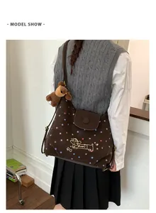 Detail of canvas tote bag featuring colorful stars, Puppy embroidery and plush bear charm