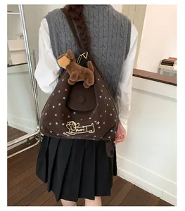 Rear view of a model wearing the brown tote bag featuring a cute puppy illustration