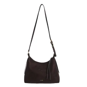 Minimalist dark brown leather half-moon shoulder bag with adjustable strap and gold logo
