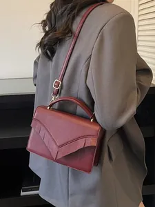 Chic burgundy leather crossbody bag with pleated V-design and adjustable strap for women