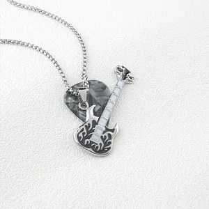 Close-up of rock guitar pendant and marble pick on a polished stainless steel chain