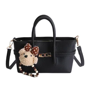 Minimalist black lychee texture baguette bag with a cute bear charm and golden buckle