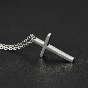 Minimalist silver titanium steel cross pendant necklace with a polished metallic finish