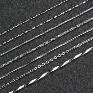 Various styles of polished stainless steel necklaces including snake and wheat chain designs