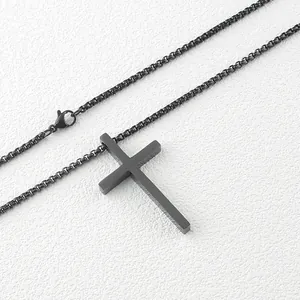 Macro shot of matte black stainless steel cross pendant with matching box chain