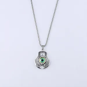 Detail of 60cm square chain with a 43mm green evil eye pendant in punk style