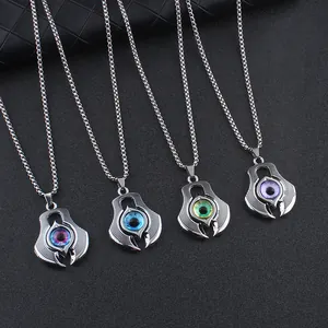 Close-up of four devil eye pendants in blue, green, and purple with punk claw frames