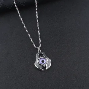 Detailed view of silver metal evil eye pendant with purple iris and claw setting