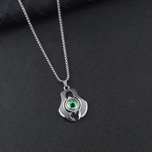 Close-up of gothic demon eye pendant on a silver box chain over dark textured background