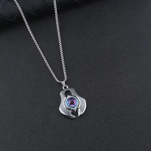 Detailed view of evil eye pendant with realistic blue-purple pupil on silver box chain