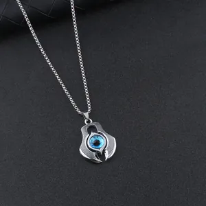 Men's silver evil eye pendant necklace with blue eye detail on black background