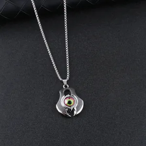 Punk demon eye pendant necklace in silver with realistic green iris on black background