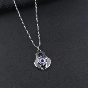 Gothic silver devil eye pendant necklace for men with purple eyeball on black textured surface