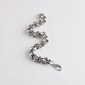 Detailed view of silver skull bracelet in Gothic style with lobster clasp closure
