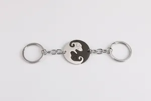 Macro shot of Yin Yang dog split pendant keychains in polished silver and black steel