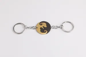 Detail of dog pendant couple keychain set with interlocking gold and black puppy charms
