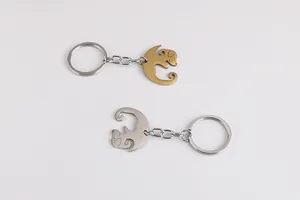 Detail of cute dog-shaped hollow metal keychains in gold and silver stainless steel