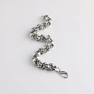 Men's retro skull link bracelet in antique silver finish with lobster clasp closure