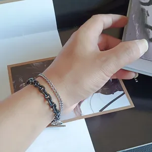 Double-layered black and silver stainless steel chain bracelet with a toggle clasp