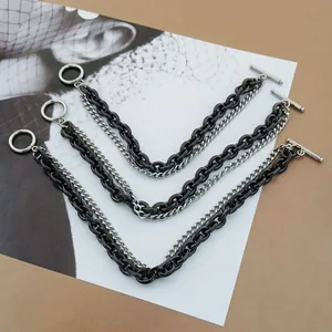 Detail of layered black and silver link chains with OT toggle clasp and vintage textures