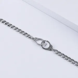 Detail of 7mm stainless steel Cuban chain bracelet with Freedom engraved handcuffs