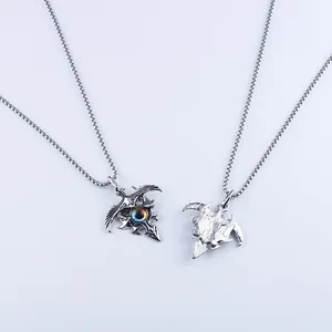 Detailed view of dark gothic eagle necklace showing the magic eye pendant front and back