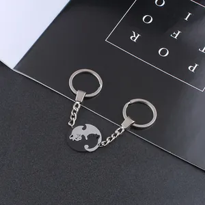 Detail of interlocking black and white cat pendants forming a yin yang heart shape