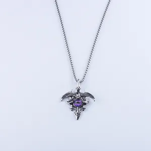 Macro detail of gothic eagle necklace featuring a purple evil eye dragon stone pendant