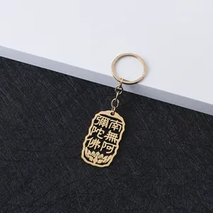 Close-up of golden stainless steel keychain with hollowed Buddhist scripture engraving