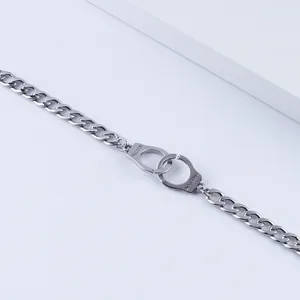 Unisex stainless steel curb chain bracelet featuring freedom engraved handcuffs
