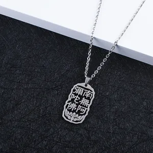 Close-up of hollowed-out Buddhist pendant with Namo Amituofo script and lotus motif