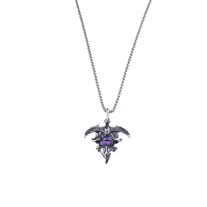 Gothic eagle pendant necklace featuring a purple evil eye gemstone and vintage silver finish