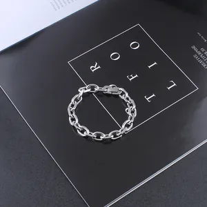 Macro shot of silver stainless steel thick link chain bracelet on a black background