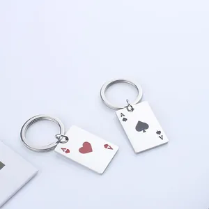 Close-up of Ace of Hearts and Spades poker card pendants on stainless steel keychains