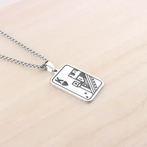 Silver stainless steel King of Hearts playing card pendant necklace on wooden background