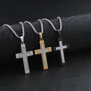 Detailed view of dual-layer cross pendants in silver, gold, and black stainless steel