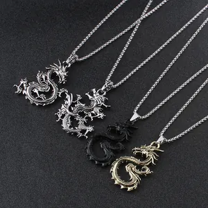 Detailed relief of dragon pendants in gold silver and black with intricate scales