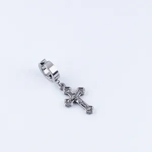 Detail of silver stainless steel cross hoop earring with religious relief carving
