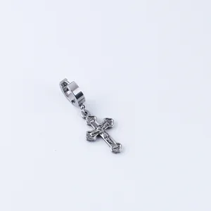 Detailed close-up of a silver stainless steel hoop earring with a cross crucifix pendant