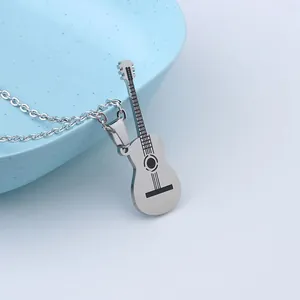 Close-up detail of a stainless steel guitar pendant with black engraved strings