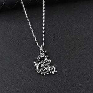 Silver dragon pendant necklace with detailed scales and claws on a square box chain link